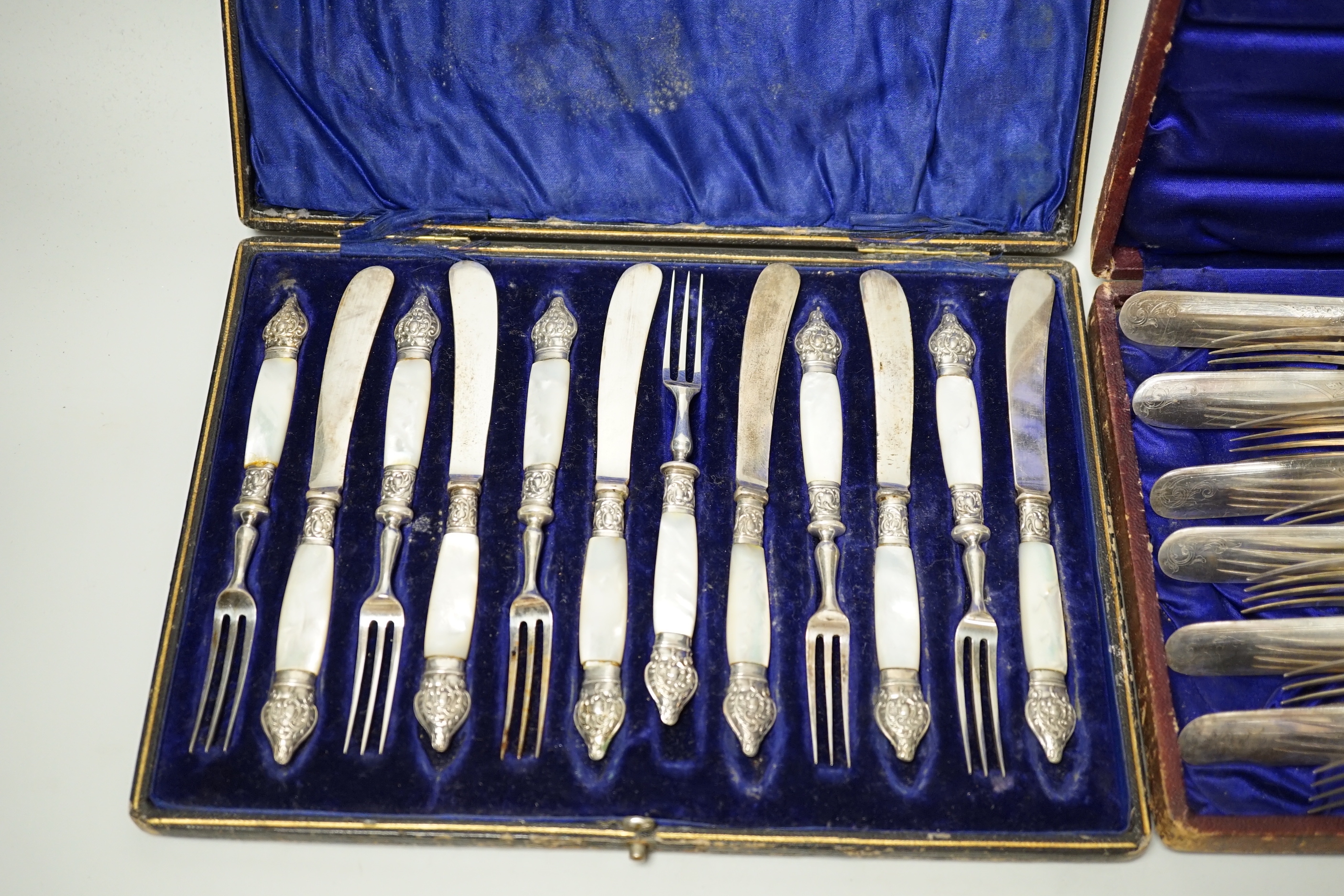 Two cased sets of silver flatware including teaspoons and pair of small servers and two cased sets of plated flatware.